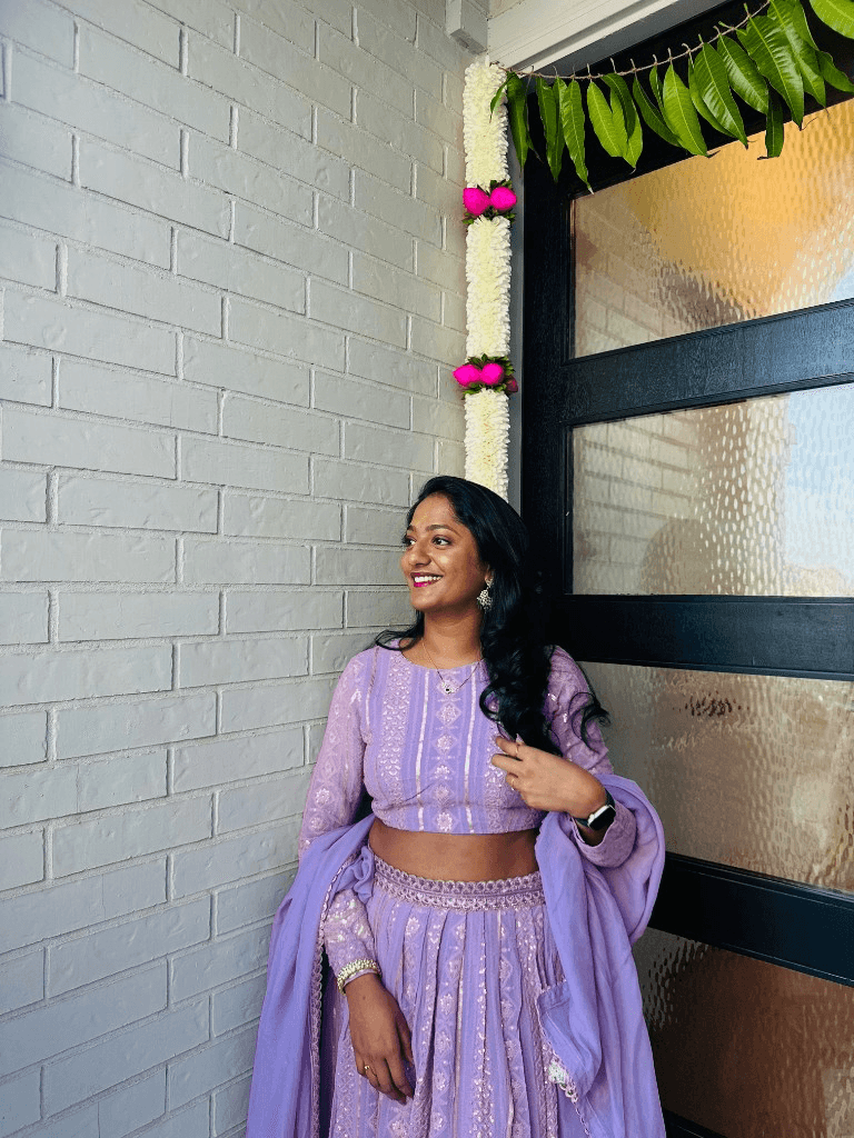 Portrait in a lavender traditional outfit by a decorated doorway